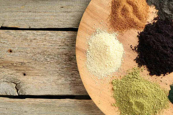 stock image Different superfood powders on wooden table, top view. Space for text