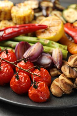 Delicious grilled vegetables on grey table, closeup