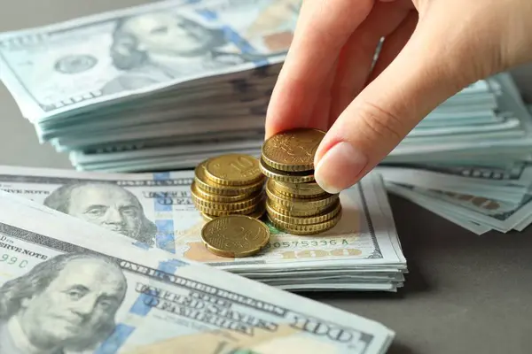 stock image Woman stacking coins at grey table, closeup