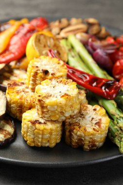 Delicious grilled vegetables on grey table, closeup