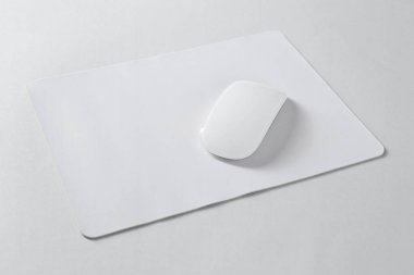 Wireless mouse and mousepad on white background clipart