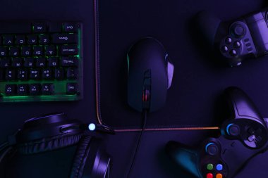 Bilgisayar faresi, RGB klavyesi, oyun denetleyicileri ve siyah arkaplan kulaklığı, üst görünüm