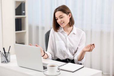 Ergen, evde bilgisayarla görüntülü konuşma yapıyor. Uzak çalışma