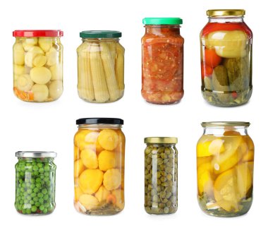 Farklı turşulu cam kavanozlar ve beyaz arka planda konserve yiyecekler.