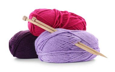 Many bright yarns and knitting needles isolated on white clipart