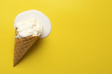 Sarı arka planda erimiş dondurma, üst manzara. Metin için boşluk