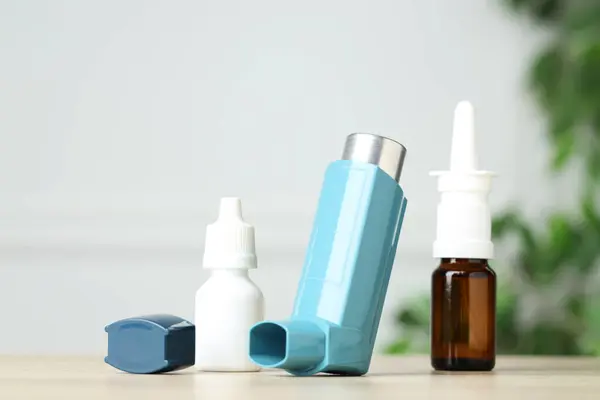 stock image Different asthma medications on wooden table, closeup