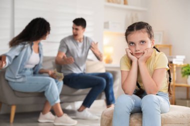 Boşanma kavramı. Kızgın çift evde tartışıyor, üzgün kızlarına odaklanıyor.