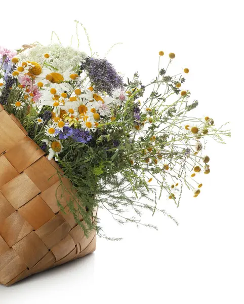 stock image Beautiful wildflowers in bag isolated on white