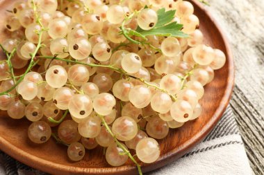 Taze kuşüzümü ve yeşil yaprak ahşap masada, yakın plan.