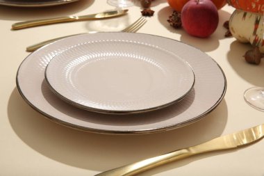 Bej arkaplanda sonbahar dekoru olan güzel masa ayarları, yakın plan