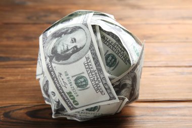 Tahta masada dolardan yapılmış top, yakın plan.