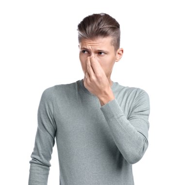 Genç adam beyaz arka planda sinüzitten muzdarip.