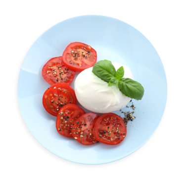 Lezzetli burrata peyniri, domates, fesleğen ve baharatlar beyaza izole edilmiş.