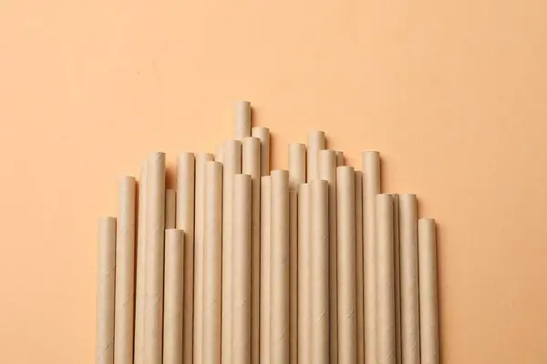 stock image Bamboo drinking straws on beige background, top view