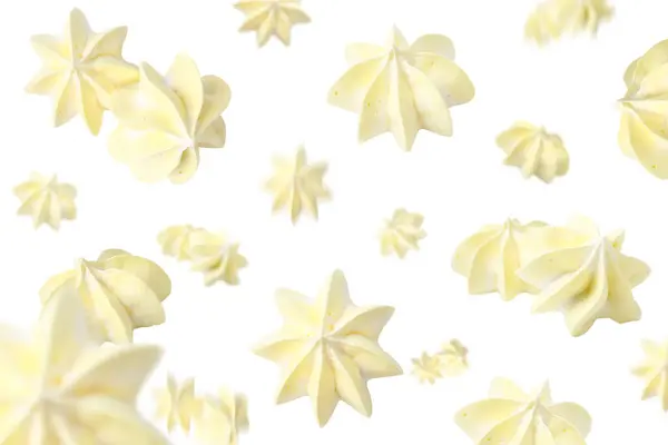 stock image Delicious meringue cookies in air on white background