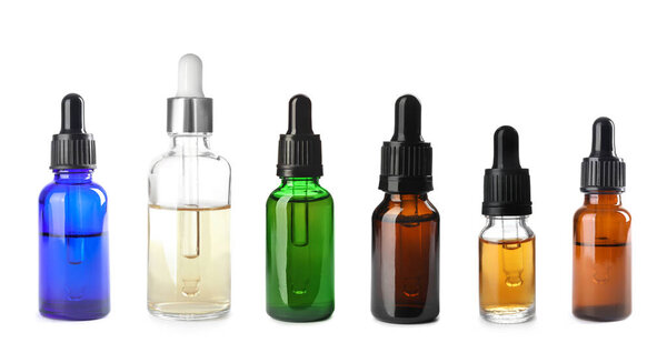 Эфирные масла Орегано в бутылках на белом фоне, коллекция