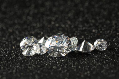 Beautiful dazzling diamonds on dark shiny background, closeup clipart