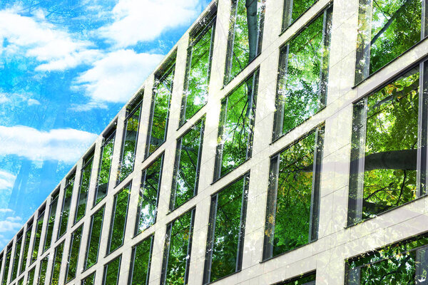 Environment preservation. Double exposure of modern building and trees, low angle view