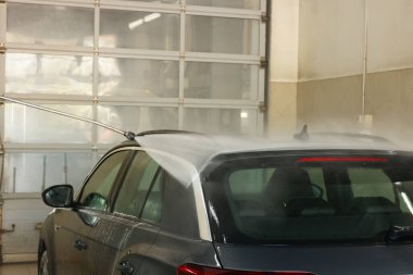 Araba yıkamada yüksek basınçlı su jeti ile oto yıkama, yakın çekim.