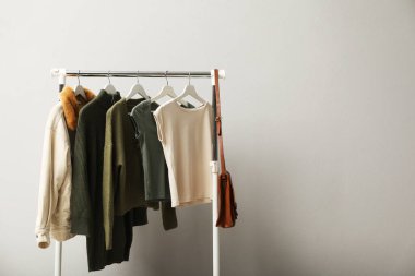 Giysilerle ve çantalarla ışık duvarının yanına dizilin. Metin için boşluk