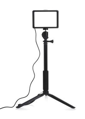 Professional lighting equipment with tripod isolated on white clipart