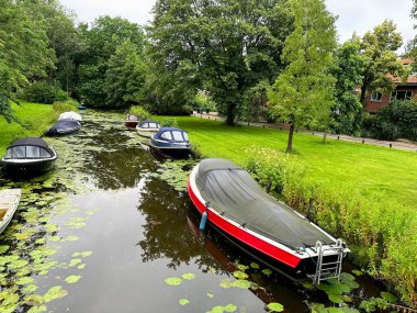 Picturesque view of canal with moored boats clipart