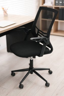 Siyah sandalye, dizüstü bilgisayar ve masa