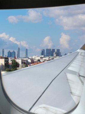 Airplane taking off or landing, view on city from window clipart