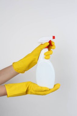Elinde sprey şişeyle arka planda tuvalet temizleyicisi tutan kadın, yakın plan.