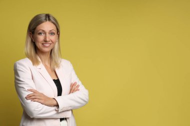 Sarı arka planda gülümseyen güzel bir kadının portresi, metin için boşluk