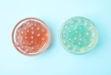 Açık mavi arka planda parlak tapyoka incileri, düz uzanmış