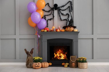 Room with fireplace decorated for Halloween. Festive interior