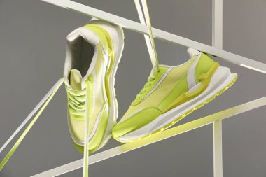 Gri arka planda spor ayakkabılarının şık sunumu