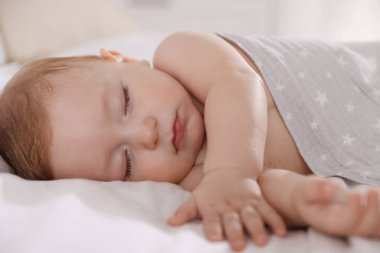 Evdeki yatakta uyuyan tatlı bir bebek.