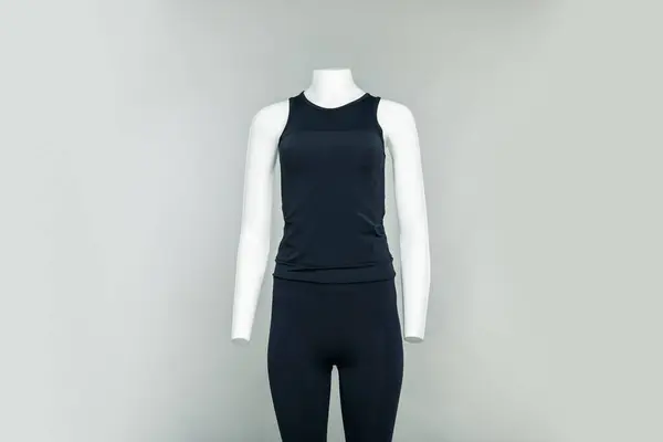 Female mannequin with stylish sports outfit on light grey background