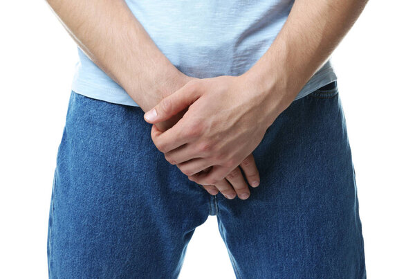 STD (sexually transmitted diseases). Man suffering from symptoms on white background, closeup