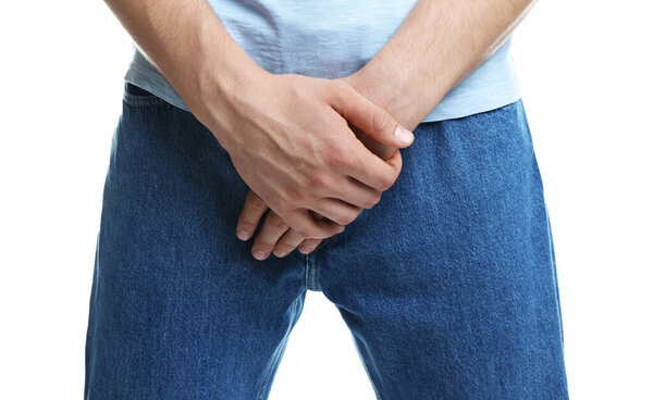 STD (sexually transmitted diseases). Man suffering from symptoms on white background, closeup