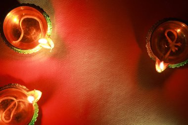 Diwali kutlaması. Kırmızı zemin üzerinde Diya lambaları, düz yatıyordu. Metin için boşluk