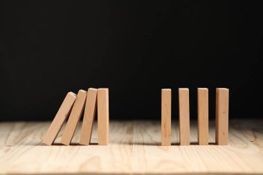 Domino etkisi. Tahta masaya bloklar düşüyor. Metin için boşluk