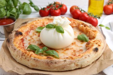 Burrata peynirli, fesleğenli, soslu ve domatesli lezzetli pizza.