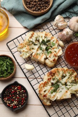 Ahşap masada soslu ve baharatlı leziz ızgara karnabahar bifteği.