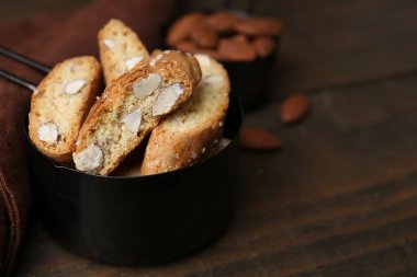 Lezzetli bademli bisküviler (Cantuccini) ahşap masada kepçeyle, yakın plan. Metin için boşluk