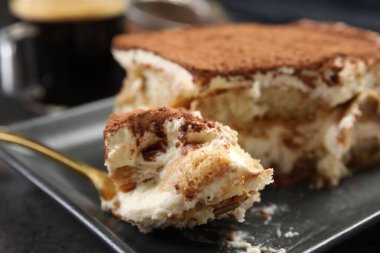 Siyah masada lezzetli tiramisu yiyorum, yakın plan.