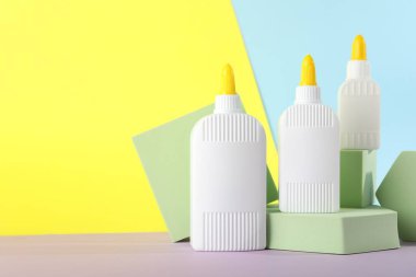 Masada renk arkaplanına karşı tutkal ve podyum şişeleri