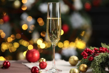 Bulanık Noel ışıklarına karşı cam ve dekor içinde şampanya, bokeh etkisi