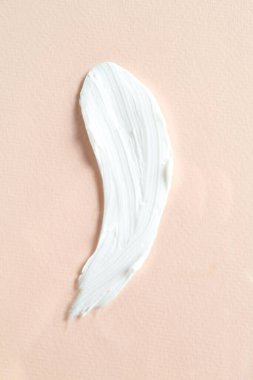 Bej arka planda kozmetik ürünlerin karışımı, üst görünüm