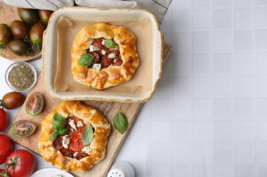 Beyaz fayanslı masada domatesli, fesleğenli ve peynirli leziz galetler. Metin için boşluk