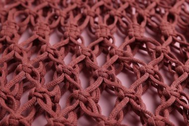 Pembe arka planda Macrame alışveriş çantası, yakın plan.