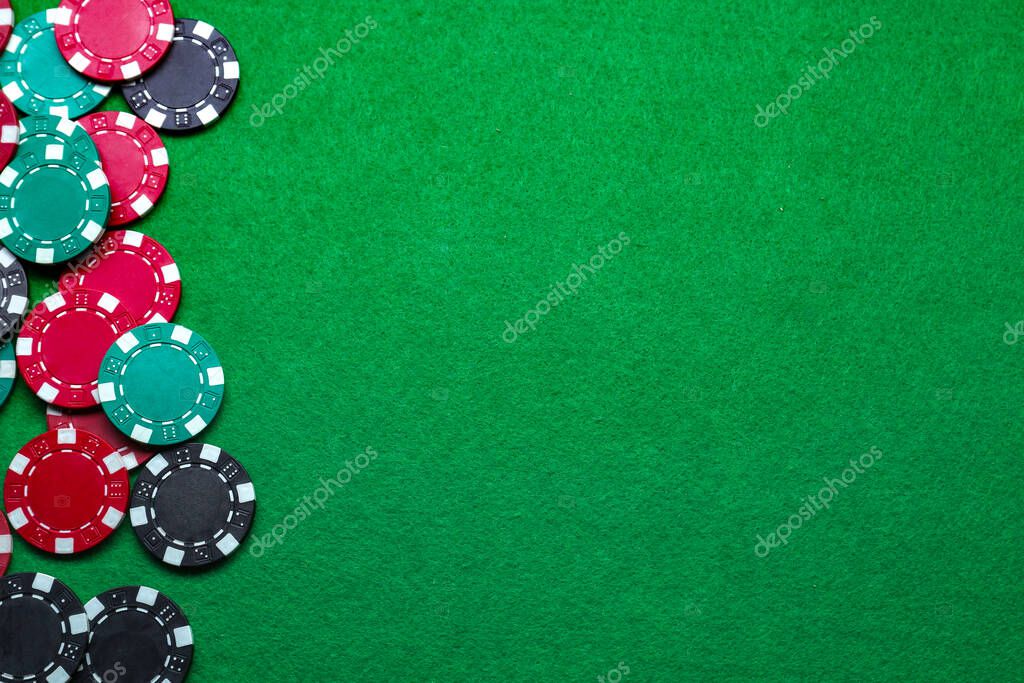 Poker game. Casino chips on green table, flat lay